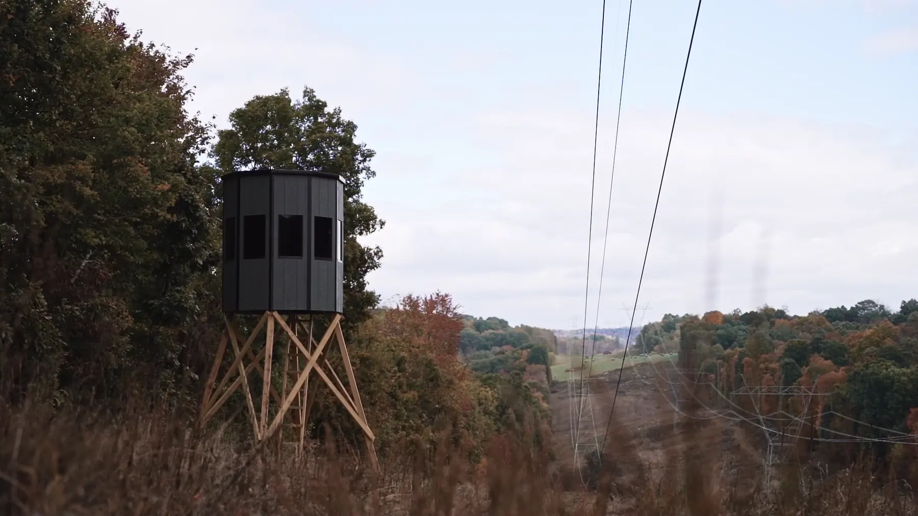 A NXTGen 6 Foot Deluxe blind on a wooden tower at the edge of a field.